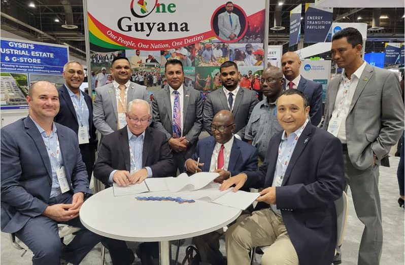 Chief Executive Officer of Ithaca Energy Partners Inc (IEP), Linden Edmondson (second right sitting) along with Minister of Natural Resources, Vickram Bharrat (second left standing), and CEO of GO-Invest Dr Peter Ramsaroop (third from left standing) with other members of the Guyanese delegation at the Offshore Technology Conference (OTC) in Houston, Texas. They are seen here with representatives of Excalibar Minerals LLC during the signing of the MoU