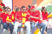 PPP GS, Bharrat Jagdeo, hands over speaking notes to Irfaan Ali at a recent rally of the party