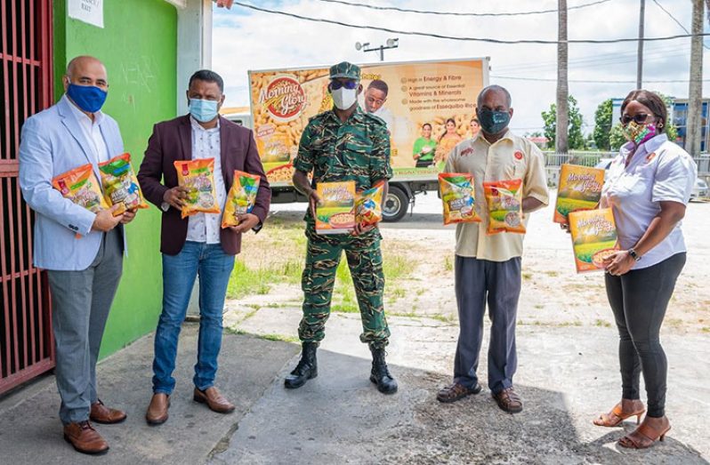 CGX Energy Inc. Executive Director, Professor Suresh Narine; Minister within the Ministry of Public Works, Deodat Indar; CDC Director-General, Lieutenant-Colonel Kester Craig and others pose with some of the items that were donated