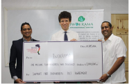 BRITCHAM’s Secretary, Anand Harrilall, hands over check to Iwokrama’s CEO, Dane Gobin, in the presence of British High Commissioner, Joseph Fisher (centre)