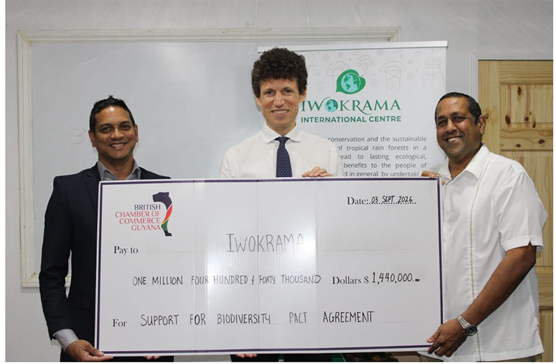 BRITCHAM’s Secretary, Anand Harrilall, hands over check to Iwokrama’s CEO, Dane Gobin, in the presence of British High Commissioner, Joseph Fisher (centre)