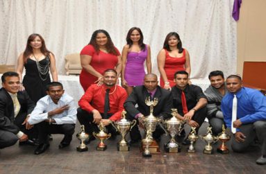 SOME members of the victorious Jaguar team pose with their winnings. Their spouses are in the background. (Pictures courtesy of Bobby Ramlagan).
