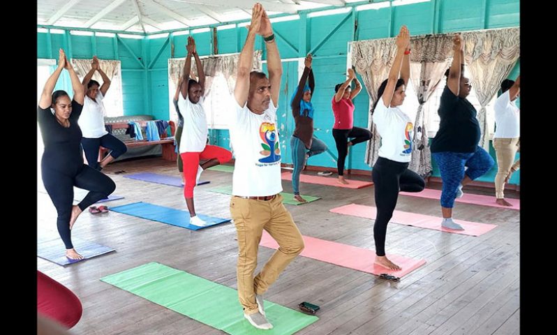 Women prisoners engaging in yoga