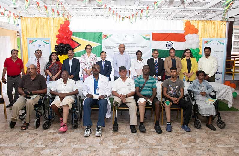 Standing from second left are: KPIL representative Anagha Poojari, Project Head for KPIL P.K Mohanty, High Commissioner of Belize to Guyana Gale Miller Garnett, High Commissioner of India to Guyana, Dr. Amit Telang, Minister of Health Dr. Frank Anthony, Deputy Programme Manager in Health Sector Development at CARICOM Dr. Serena Bender Pelswidsk, and  third from right, Director of Disability and Rehabilitation Services in Guyana Dr. Ariane Mangar, flanked by other officials, and beneficiaries (Delano Williams Photo)
