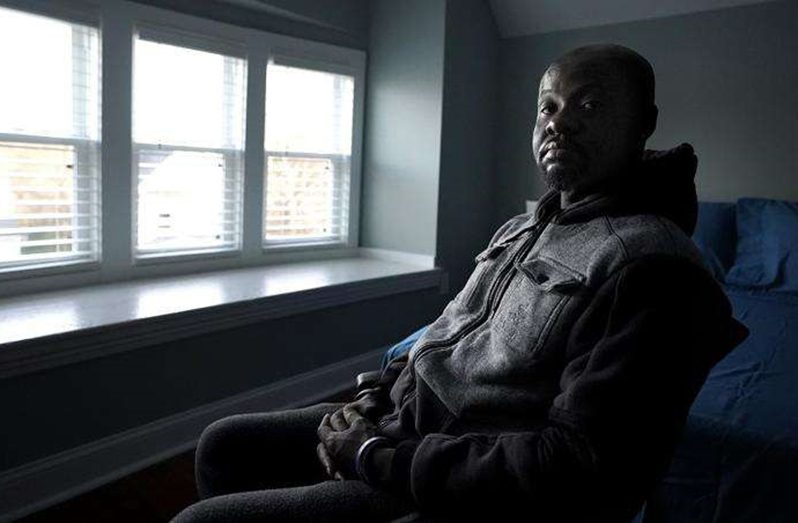 Orville Howden, 39, of Jamaica, sits for a photograph on Wednesday, December 1, 2021, at a home recently renovated by the LGBT Asylum Task Force, in Worcester, Mass. Howden, a gay man who moved into the house in November of 2021, said he fled Jamaica in October of 2020 after his roommate in Montego Bay was killed for being gay.