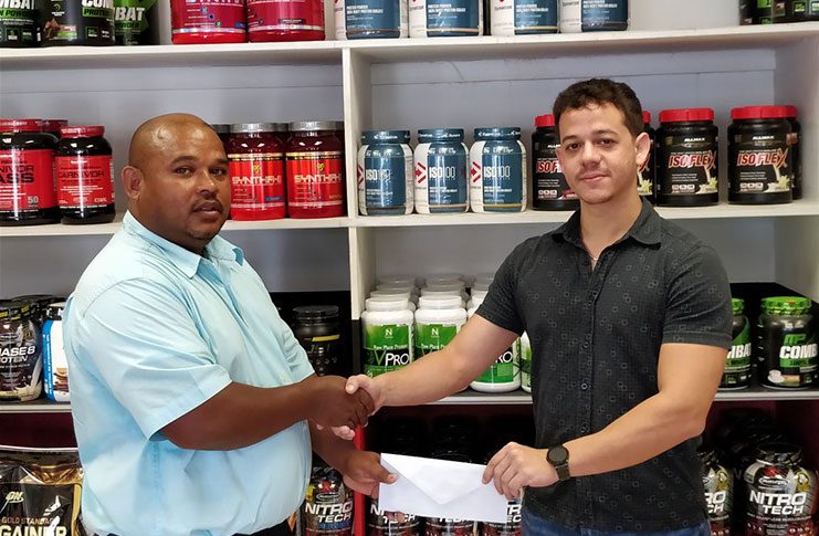 Jamie McDonald (right) of Fitness Express hands over the sponsorship package to GAPLF treasurer, Colin Austin.