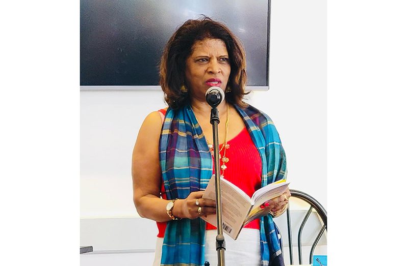 Poet Janet Naidu reading a poem from River Crossing during the launch