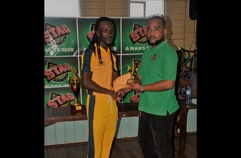 Man-of-the-match in the BCB STAG Beer 40-Over Final, Jason Sinclair, receives his Award from a representative of the company.
