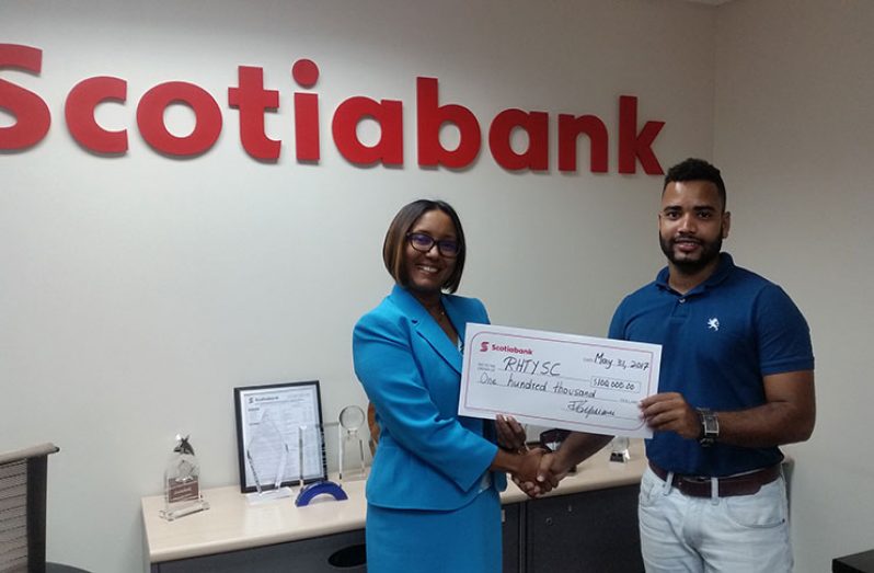 Scotia Bank Marketing Executive, Jennifer Cipriani hands over sponsorship cheque to Shaw Perriera, RHTY&SC Club Captain.