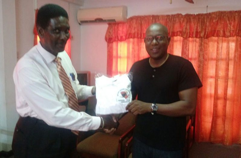 In this photo Mr. Chase (left) receives the jerseys from GBA President Steve Ninvalle.