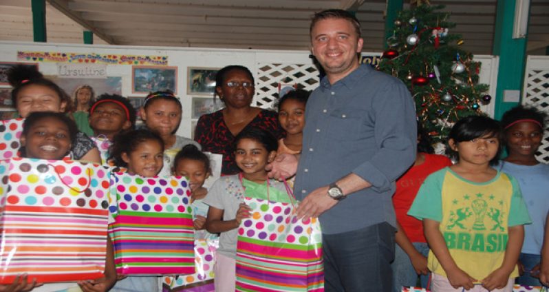 Ramada Georgetown Princess General Manager Uger Turetgen and Sales and Marketing Director Petal Ridley with the girls of St Ann’s Orphanage