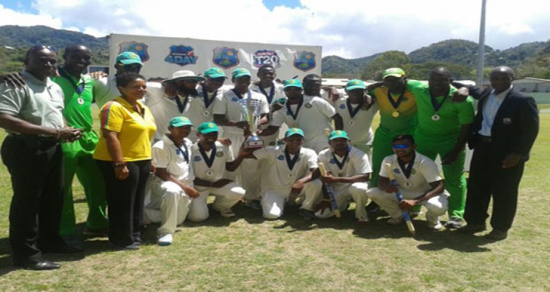Newly crowned regional four-day cricket champions Guyana Jaguars pose with the WICB/PCL Trophy after defeating Windwards Volcanoes by an innings in Dominica yesterday.