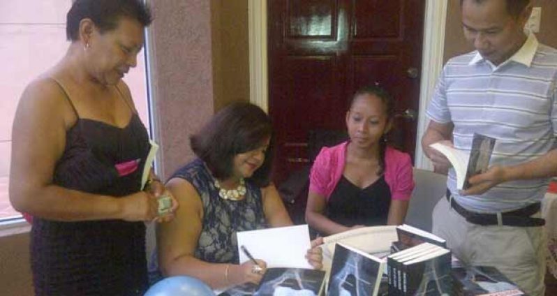 Julia Kanhai signing copies of her book at Saturday’s launch