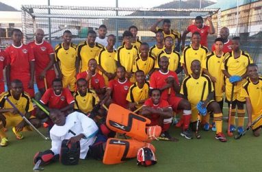 Guyana National Junior squad (in gold) and Paragon players pose after their friendly match.