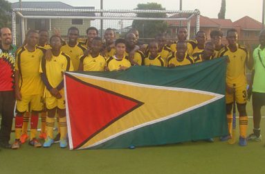 Guyana’s National Junior Men's Team pose with coaches Dwayne Alleyne and Robert Fernandes at the end of their match against Trinidad.