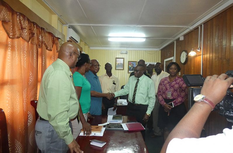 Regional Chairman Renis Morian shaking hands with representatives of the Kalibur security firm, following their meeting