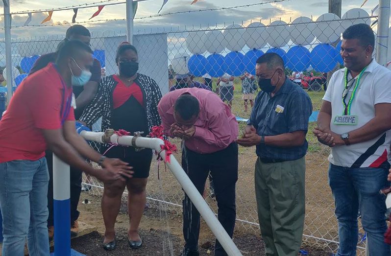 Minister Croal drinks water provided through the newly commissioned system