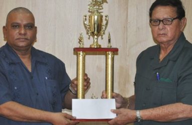 Chief Executive Officer of the Berbice River Bridge Company Inc. Omadat Samaroo (left) presents the sponsorship cheque to Honorary president of the KMTC Retired Chief Justice Cecil Kennard.
