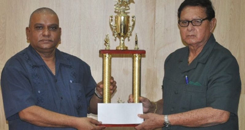 Chief Executive Officer of the Berbice River Bridge Company Inc. Omadat Samaroo (left) presents the sponsorship cheque to Honorary president of the KMTC Retired Chief Justice Cecil Kennard.