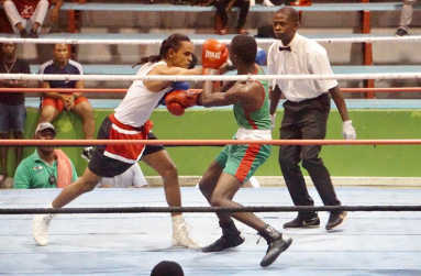 Harpy Eagles’ Kevin Allicock (left) connects to the head of GDF’s Kevin Isaacs during their flyweight contest at the National Gymnasium on Friday night.