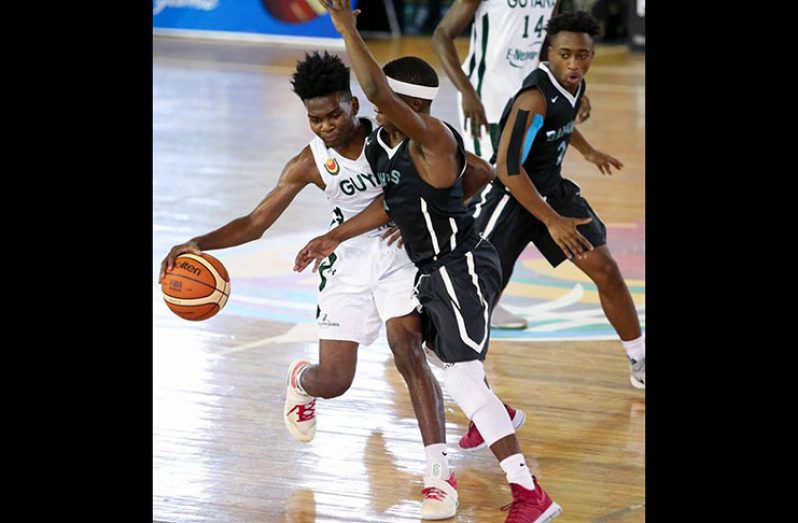 Kevon Wiggins tries to evade his Bahamas counterpart in the 2017 Centrobasket U17 championships.