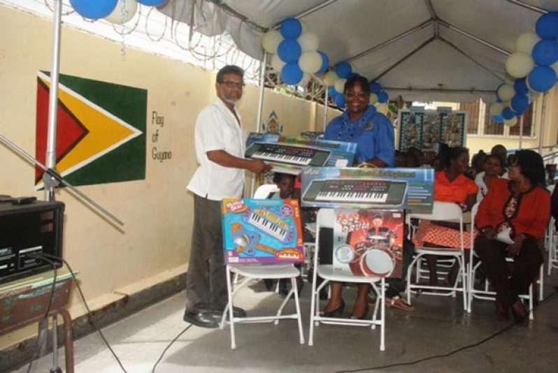 Ray Bassoo Snr hands over keyboards to East Street Nursery School, also in picture is Head Teacher Belinda Cameron