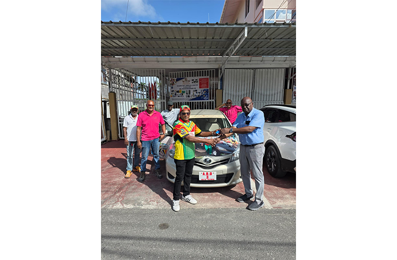 GSCL Inc. President Ian John, right, hands over the keys for the Toyota Vitz car to Uniss Yusuf with other members of Regal Legends in attendance