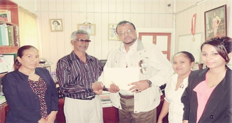 The RK Family. From left are: Ms. Annmarie Mohammed, Mr. Roshan Khan (Centre), Ms. Annie Nauth, and Ms. Kimberly Lutchman.  Talented Guyanese writer Bobby Kissoon is seen with them