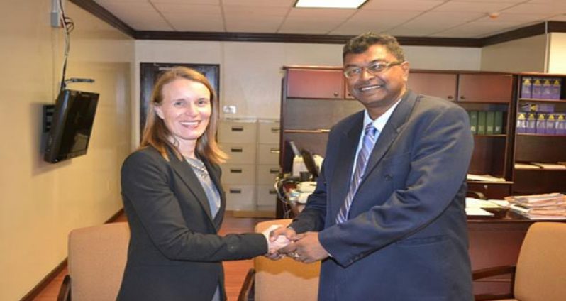Second Vice President and Minister of Public Security, Mr. Khemraj Ramjattan greeting outgoing Canadian High Commissioner to Guyana, Dr. Nicole Giles, during a courtesy call