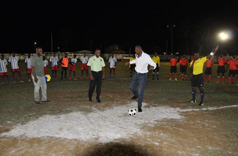 Director of Sport Christopher Jones (on ball) about to kick off the tournament officially in the presence of tournament officials and the New Amsterdam United Team (right) and Golden Stars.