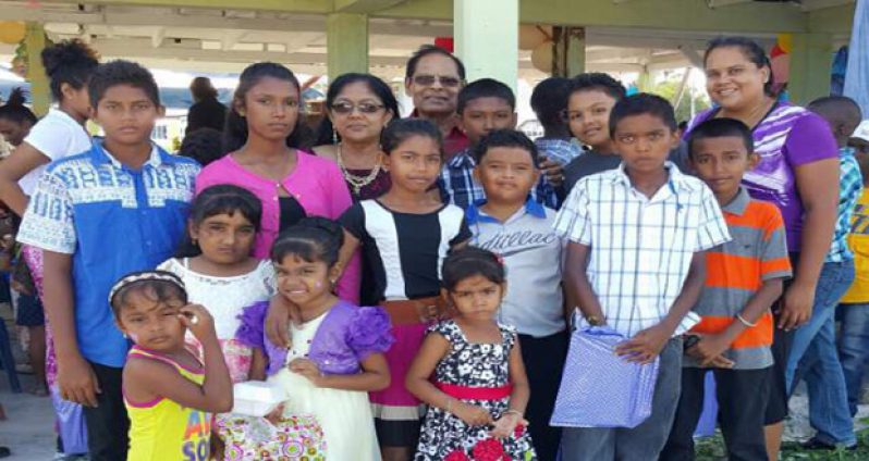 Prime Minister Moses Nagamootoo and Mrs Sita Nagamootoo pose with some of the children at the party