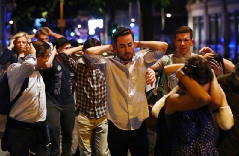 People leave the area with their hands up after an incident near London Bridge in London, Britain June 4, 2017 (REUTERS/Neil Hall)