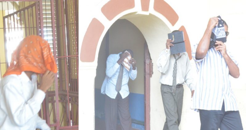 The four convicts hiding their faces at the High Court