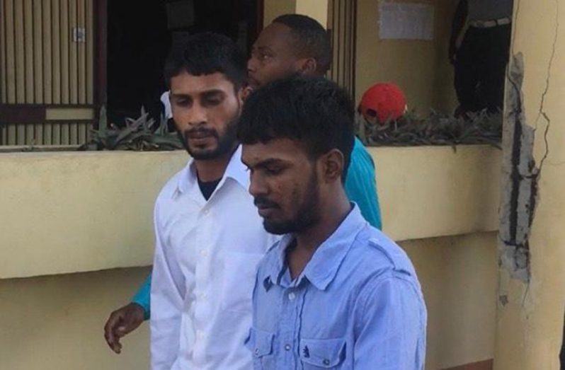 Suresh Sundat (in blue), Narine Dhanraj (in white) as they leave the Whim Magistrate’s Court