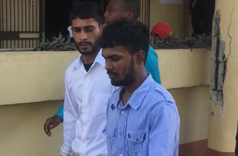 Suresh Sundat (in blue), Narine Dhanraj (in white) as they leave the Whim Magistrate’s Court