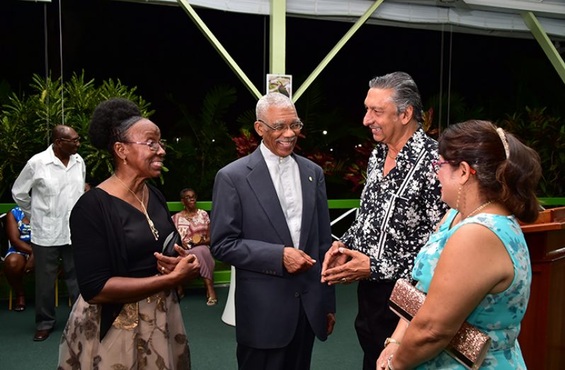 President David Granger shares a light moment with Reverend Maureen Massiah (left), of the St. Andrew’ Kirk and other invitees