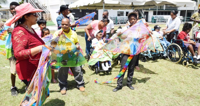 Mrs Sita Nagamootoo distributing kites to children of the Ptolemy Reid Rehabilitation Centre