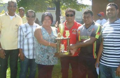 East Coast captain Krishna Deosarran collects the East Division championship trophy from OSCL treasurer Kim Sue. Others in picture (from left) are president Albert Ramcharan, assistant registrar/statistician Ranjan Persaud, East End coordinator Vish Jadunauth and PRO Ravendra Madholall.