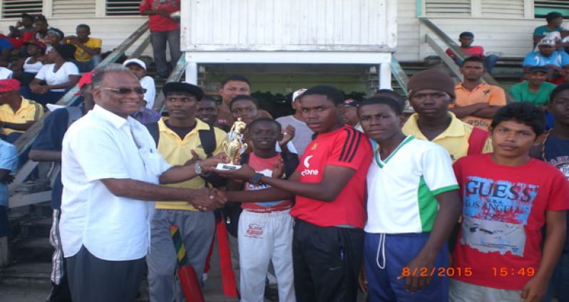 Director of Sport Neil Kumar is seen presenting one of the trophies won on the day.