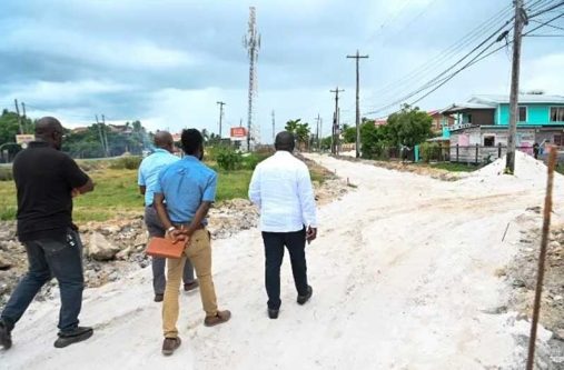 Minister within the Office of the Prime Minister with responsibility for Public Affairs, Kwame McCoy, inspects works being conducted on the foundation for the market