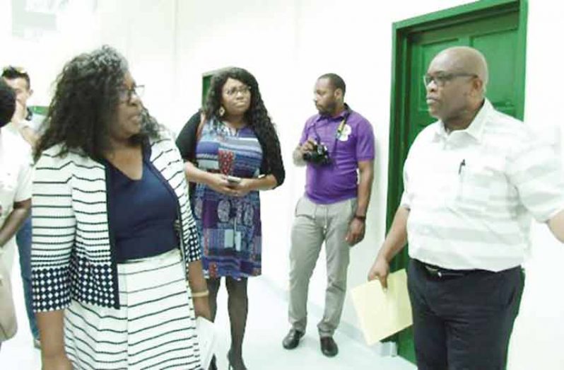 Colin Bynoe, Chief Executive Officer New Amsterdam Regional Hospital, offers Minister Dr. Karen Cummings and her team a tour of the hospital’s new laboratory facility (DPI photo)