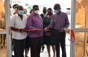 Minister of Labour, Joseph Hamilton (right) is assisted by Regional Chairman, David Armogan, to cut the ceremonial ribbon to officially open the ministry’s labour office at Corriverton (Elvin Croker photo)