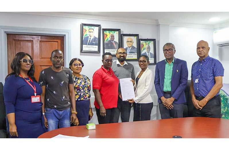 Alfred Mentore, Mayor of Georgetown; Candace Nelson, Town Clerk of M&CC; Kimberly Porter, President of GLGOU, among other officials were present at the signing