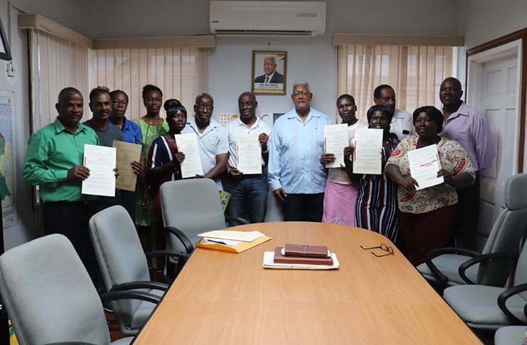 Minister Holder and his team posing with a few of the thankful recipients 