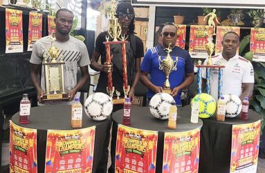 The launch party for the inaugural edition of the Bent Street ‘Champion of Champions’ futsal championship poses with the trophies following the launch of the tournament