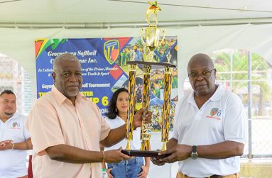 Flashback: Prime Minister Mark Phillips and GSCL president Ian John pose with one of the trophies that will be up for grabs in the tournament