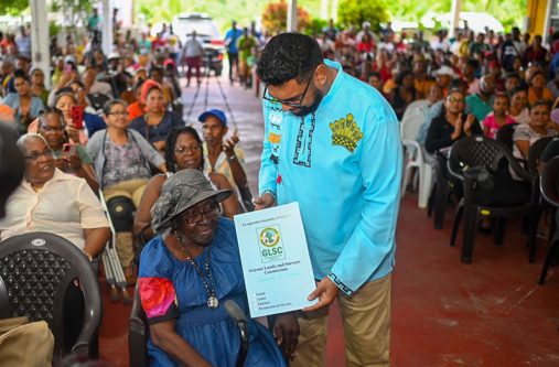 This elderly resident was among several persons who received the lease to her land on Monday (Office of the President photo)