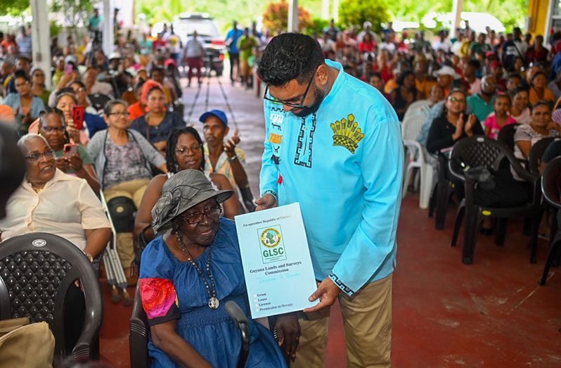 This elderly resident was among several persons who received the lease to her land on Monday (Office of the President photo)