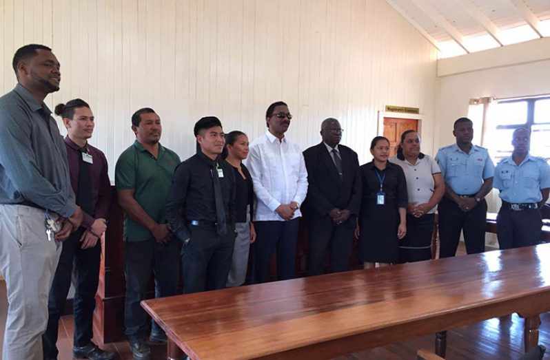 Attorney General and Minister of Legal Affairs, Basil Williams SC., [centre] flanked by Principal Magistrate Allan Wilson [left of AG], Althea Fitzpatrick Asst. Reg. Exec Officer [fourth from right], and Police Prosecutor Tishon Rodrigues [second from right]
