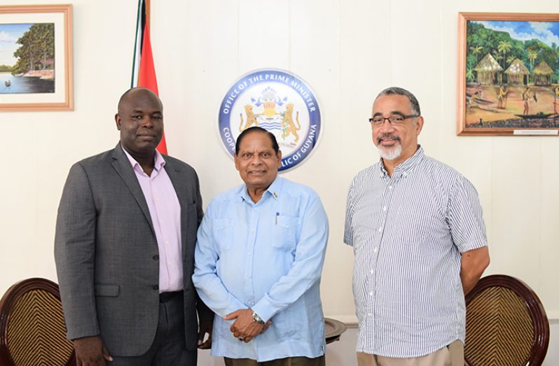 Prime Minister Moses Nagamootoo flanked by GTT Chief Executive Officer (CEO) Justin Nedd and International Regulatory and Governmental Affairs Director, Delreo Newman